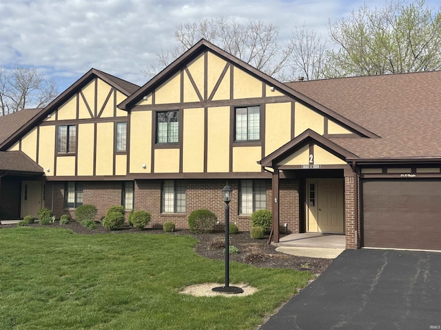 1594 William Wells Cir, Bluffton, IN 46714 - tudor house with brick siding, driveway, stucco siding, and a front yard