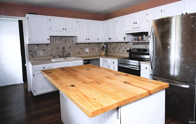 2113 W Christy Ln, Muncie, IN 47304 - kitchen featuring appliances with stainless steel finishes, a sink, butcher block counters, under cabinet range hood, and white cabinetry