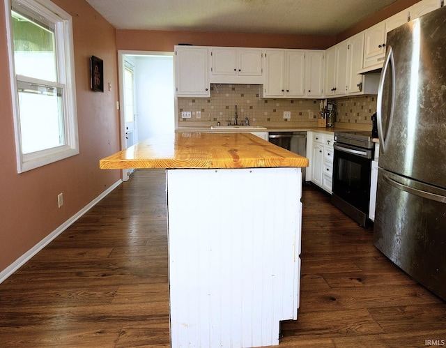 2113 W Christy Ln, Muncie, IN 47304 - kitchen with freestanding refrigerator, electric range oven, a sink, tasteful backsplash, and white cabinets