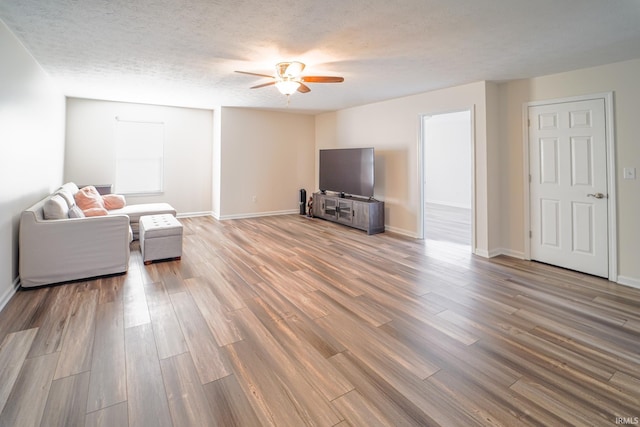 2027 Wesmar Ct, Kokomo, IN 46902 - living area featuring ceiling fan, wood finished floors, baseboards, and a textured ceiling