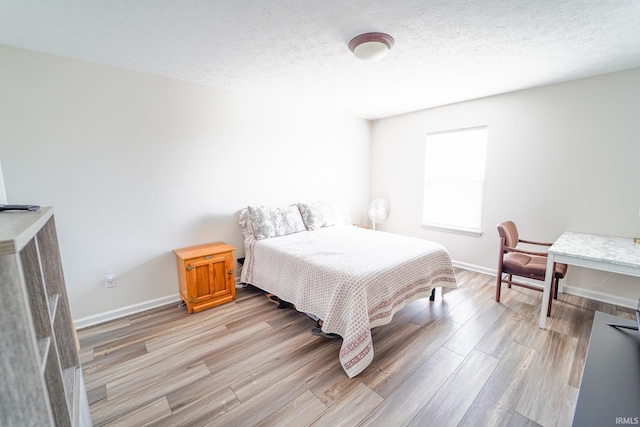 2027 Wesmar Ct, Kokomo, IN 46902 - bedroom with light wood-style flooring, baseboards, and a textured ceiling