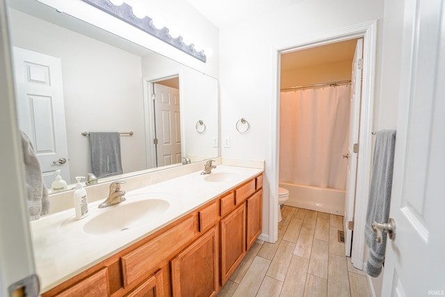 2027 Wesmar Ct, Kokomo, IN 46902 - full bathroom featuring wood finished floors, double vanity, toilet, and shower / tub combo with curtain