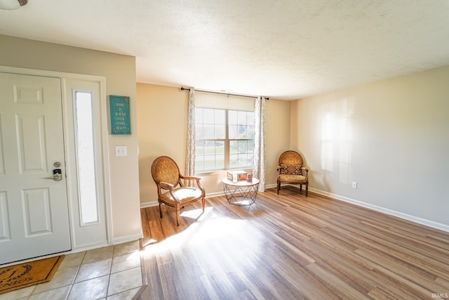 2027 Wesmar Ct, Kokomo, IN 46902 - foyer entrance featuring light wood-style floors, baseboards, and a textured ceiling