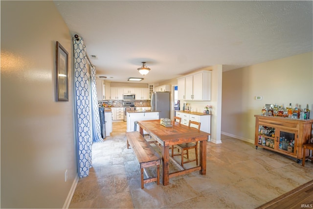 2027 Wesmar Ct, Kokomo, IN 46902 - dining area with baseboards and stone finish floors