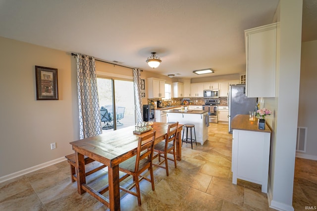 2027 Wesmar Ct, Kokomo, IN 46902 - dining room with light stone finish flooring and baseboards