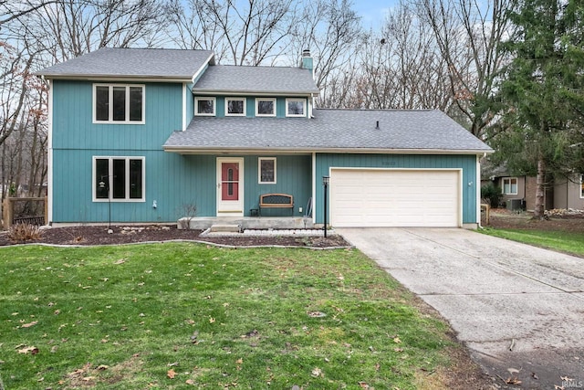 52022 Old Post Ln, Granger, IN 46530 - view of front facade with an attached garage, a chimney, concrete driveway, a front yard, and roof with shingles