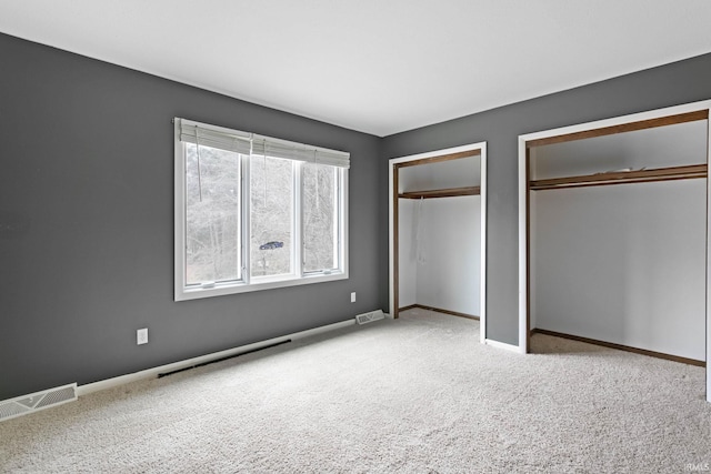 52022 Old Post Ln, Granger, IN 46530 - unfurnished bedroom featuring two closets, carpet floors, and baseboards