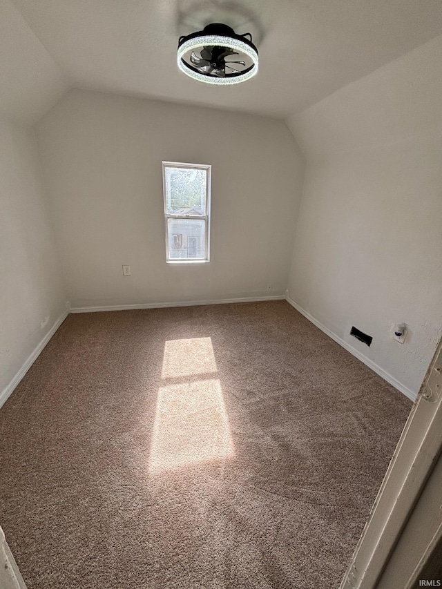 721 S Hackley St, Muncie, IN 47302 - additional living space with lofted ceiling, carpet flooring, and baseboards