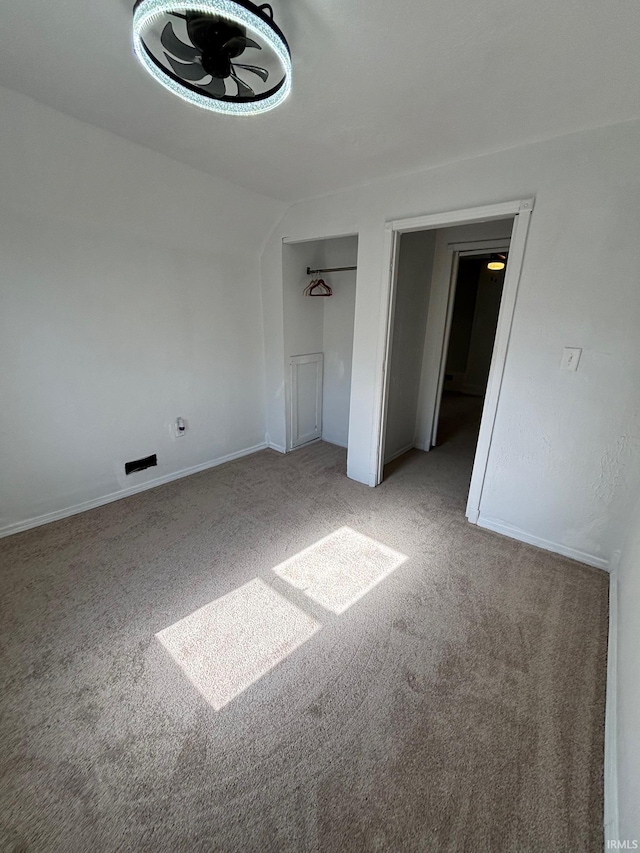 721 S Hackley St, Muncie, IN 47302 - unfurnished bedroom featuring carpet flooring, lofted ceiling, and baseboards