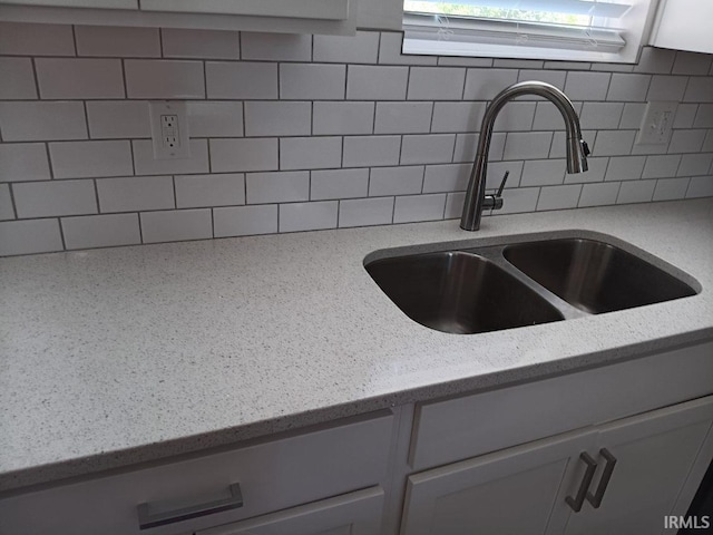 224 E 6th Ave, Ingalls, IN 46048 - kitchen view of a sink, decorative backsplash, and light stone counters