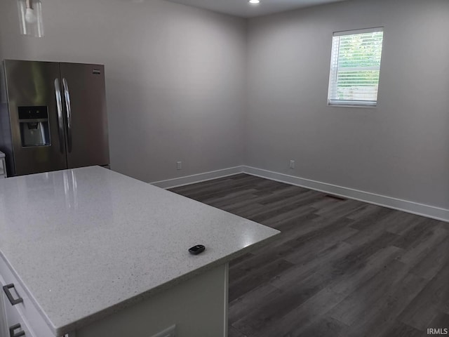 224 E 6th Ave, Ingalls, IN 46048 - kitchen with stainless steel refrigerator with ice dispenser, dark wood-type flooring, white cabinets, light stone counters, and baseboards