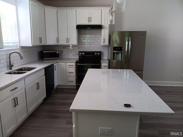 224 E 6th Ave, Ingalls, IN 46048 - kitchen with black appliances, a sink, under cabinet range hood, white cabinets, and a center island