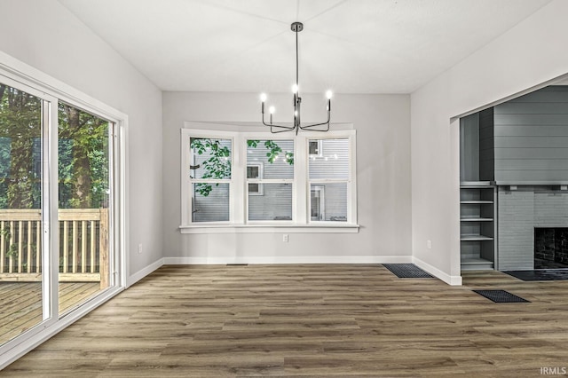 209 Marquette Ave, South Bend, IN 46617 - unfurnished dining area featuring a chandelier, wood finished floors, baseboards, and a fireplace