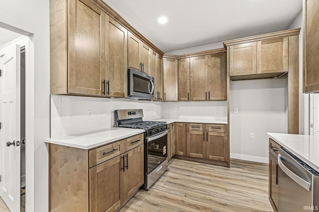 209 Marquette Ave, South Bend, IN 46617 - kitchen featuring appliances with stainless steel finishes, light wood-style floors, light countertops, recessed lighting, and baseboards
