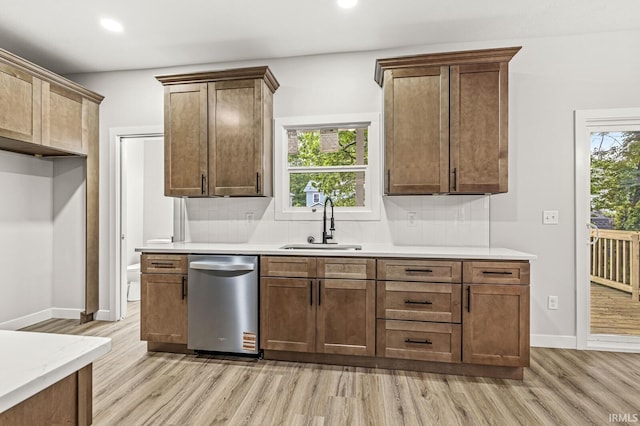 209 Marquette Ave, South Bend, IN 46617 - kitchen featuring stainless steel dishwasher, light wood-type flooring, a sink, backsplash, and recessed lighting