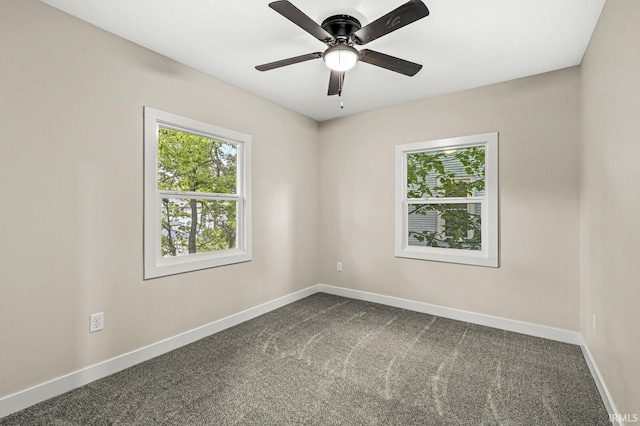 209 Marquette Ave, South Bend, IN 46617 - empty room featuring baseboards, dark carpet, and a ceiling fan