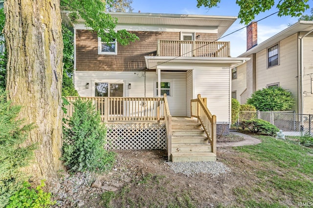 209 Marquette Ave, South Bend, IN 46617 - rear view of house featuring fence, a balcony, and a wooden deck