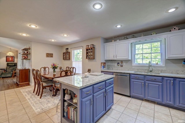 1177 E Marigold Dr, Bloomington, IN 47401 - kitchen with blue cabinets, a sink, dishwasher, white cabinetry, and plenty of natural light