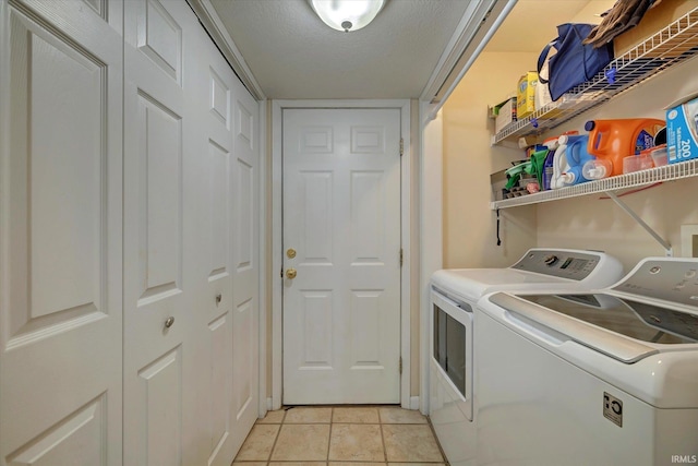 1177 E Marigold Dr, Bloomington, IN 47401 - laundry room with washing machine and dryer, light tile patterned flooring, and a textured ceiling