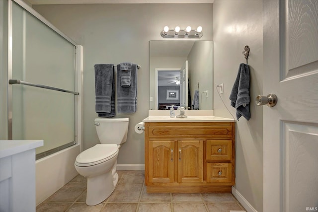 1177 E Marigold Dr, Bloomington, IN 47401 - bathroom featuring toilet, vanity, tile patterned floors, enclosed tub / shower combo, and baseboards