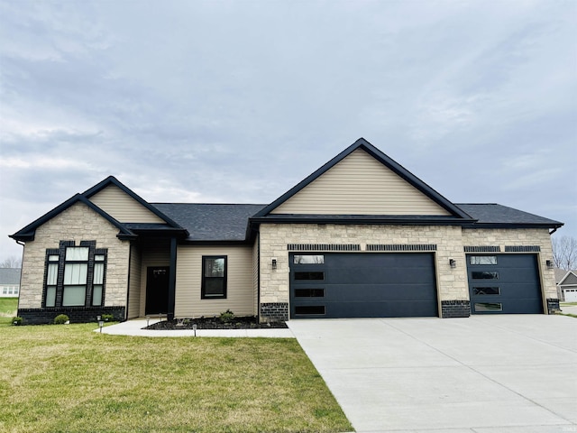 view of front of property featuring an attached garage, stone siding, a front lawn, concrete driveway, and a shingled roof