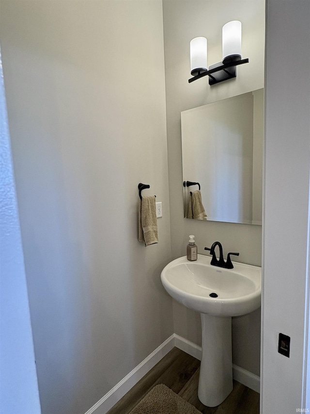bathroom featuring wood finished floors and baseboards