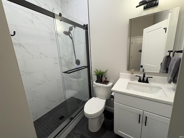 bathroom featuring a shower stall, toilet, and vanity