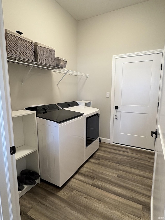 clothes washing area featuring independent washer and dryer and dark wood finished floors