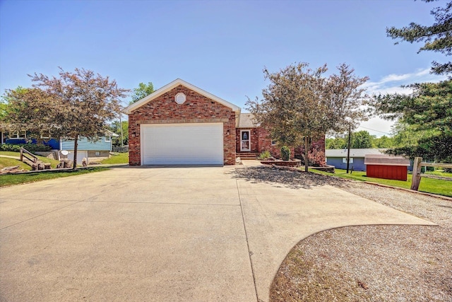 4110 E 10th St, Bloomington, IN 47408 - view of front of property with concrete driveway, brick siding, and an attached garage