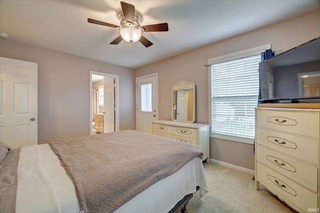 4110 E 10th St, Bloomington, IN 47408 - bedroom featuring baseboards, light colored carpet, a ceiling fan, and connected bathroom