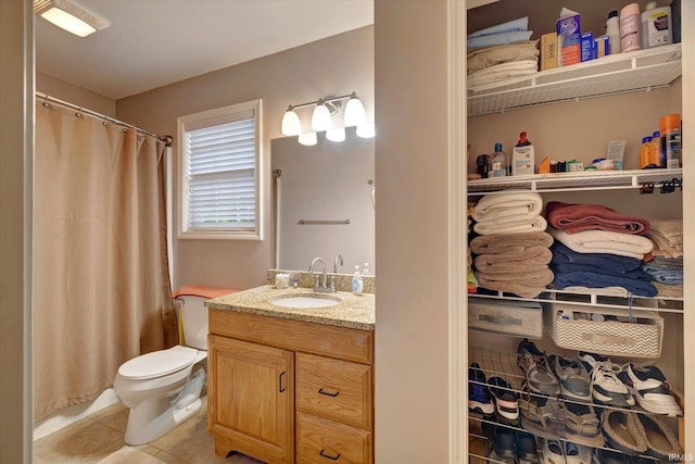 4110 E 10th St, Bloomington, IN 47408 - full bathroom featuring vanity, tile patterned floors, toilet, and a shower with curtain