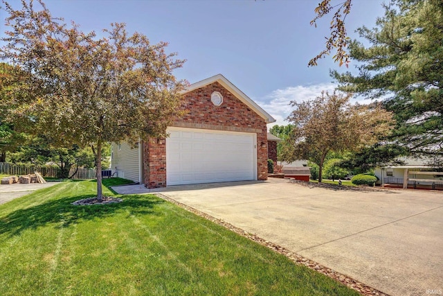 4110 E 10th St, Bloomington, IN 47408 - view of front of home with brick siding, a garage, and driveway