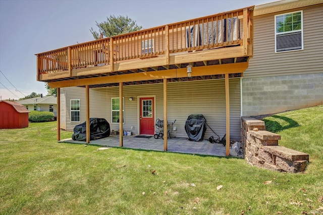 4110 E 10th St, Bloomington, IN 47408 - rear view of property featuring a lawn, a patio, a wooden deck, and a shed