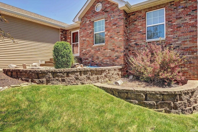 4110 E 10th St, Bloomington, IN 47408 - view of side of home featuring brick siding and a lawn