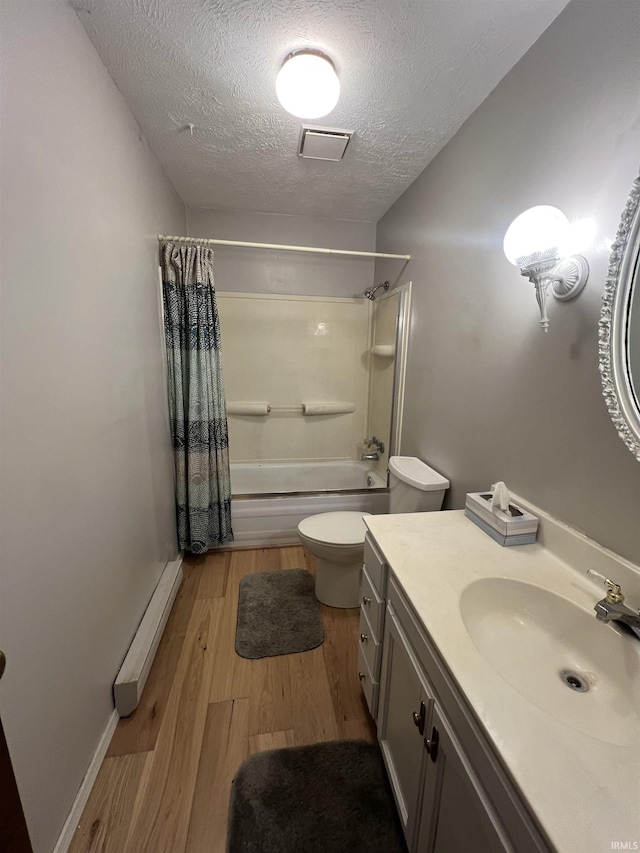 3613 Robin Dr, Kokomo, IN 46902 - bathroom featuring a textured ceiling, shower / bath combo, toilet, wood finished floors, and vanity