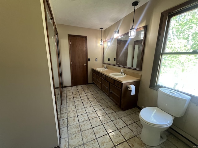 3613 Robin Dr, Kokomo, IN 46902 - full bathroom with a baseboard heating unit, healthy amount of natural light, toilet, and double vanity