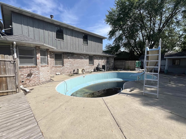 3613 Robin Dr, Kokomo, IN 46902 - view of swimming pool featuring a water slide, fence, an empty pool, and a patio area