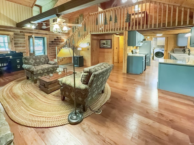 3508 Kampbell Cliff Rd, Birdseye, IN 47513 - living area with washer / clothes dryer, light wood finished floors, high vaulted ceiling, wooden walls, and a ceiling fan