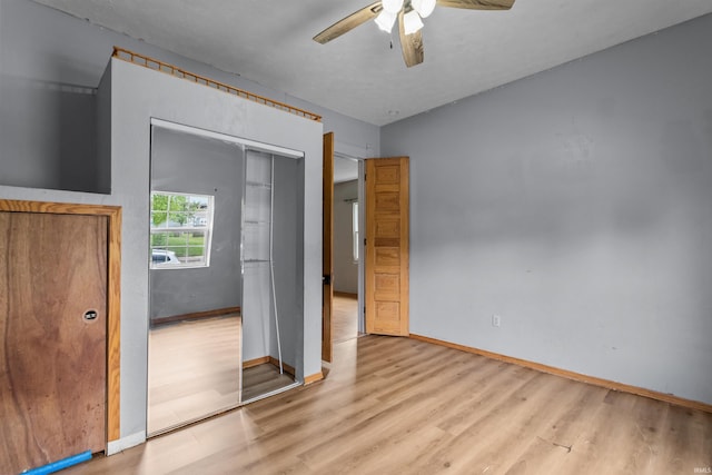1227 S Main St, Kokomo, IN 46902 - unfurnished bedroom featuring wood finished floors, baseboards, ceiling fan, and a closet