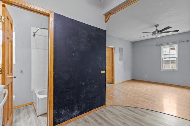 1227 S Main St, Kokomo, IN 46902 - spare room with wood finished floors, electric panel, a ceiling fan, and baseboards
