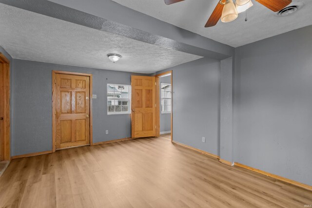 1227 S Main St, Kokomo, IN 46902 - unfurnished bedroom featuring wood finished floors, baseboards, a textured ceiling, and ceiling fan