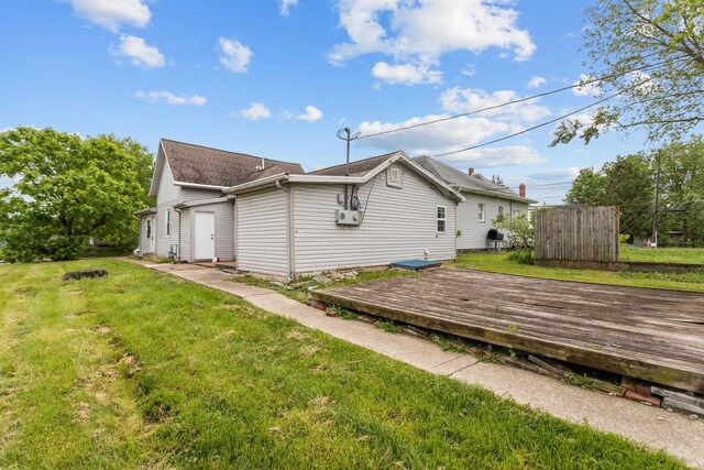 1227 S Main St, Kokomo, IN 46902 - view of side of home with a wooden deck, a lawn, and roof with shingles