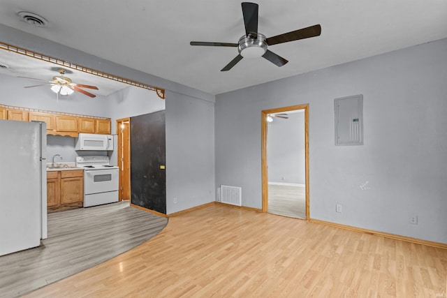 1227 S Main St, Kokomo, IN 46902 - unfurnished living room with ceiling fan, electric panel, and light wood-style floors