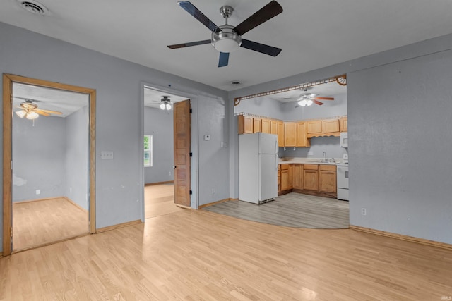 1227 S Main St, Kokomo, IN 46902 - unfurnished living room featuring light wood-style floors, a sink, a ceiling fan, and baseboards