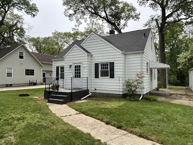 3534 Oakcrest Dr, South Bend, IN 46615 - back of property with roof with shingles, a lawn, and a chimney