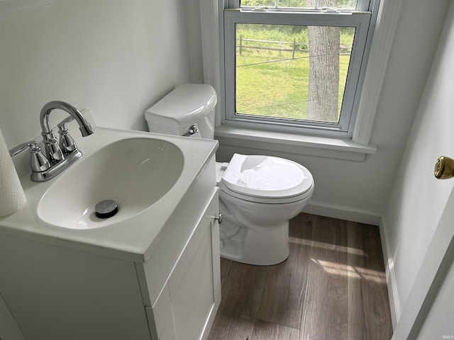 3534 Oakcrest Dr, South Bend, IN 46615 - bathroom with toilet, wood finished floors, and vanity