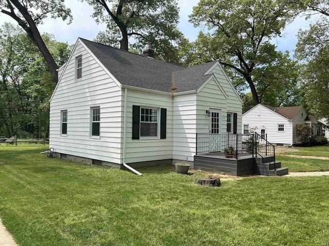 3534 Oakcrest Dr, South Bend, IN 46615 - view of front of property featuring roof with shingles, a front yard, a chimney, and a deck