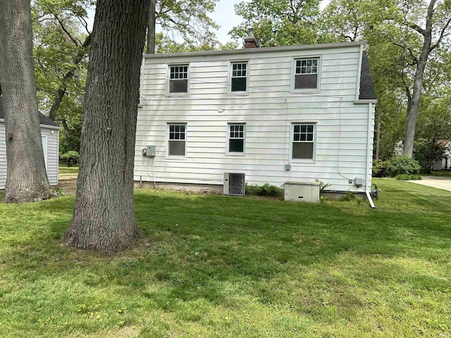 3534 Oakcrest Dr, South Bend, IN 46615 - back of property with cooling unit, a yard, and a chimney