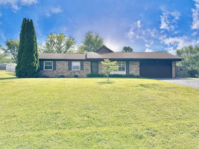 ranch-style home with asphalt driveway, brick siding, a garage, and a front yard