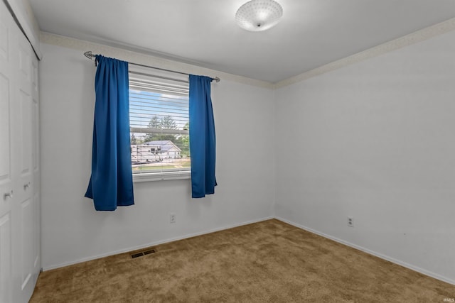 carpeted empty room with baseboards